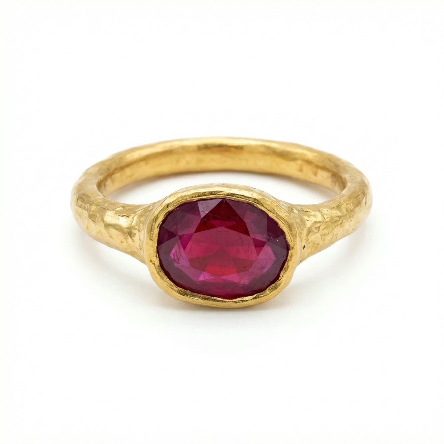 Gold 22ct handcrafted ring with a ruby gemstone on a white background
