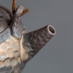 Close-up of a metallic object with a textured surface on a gray background