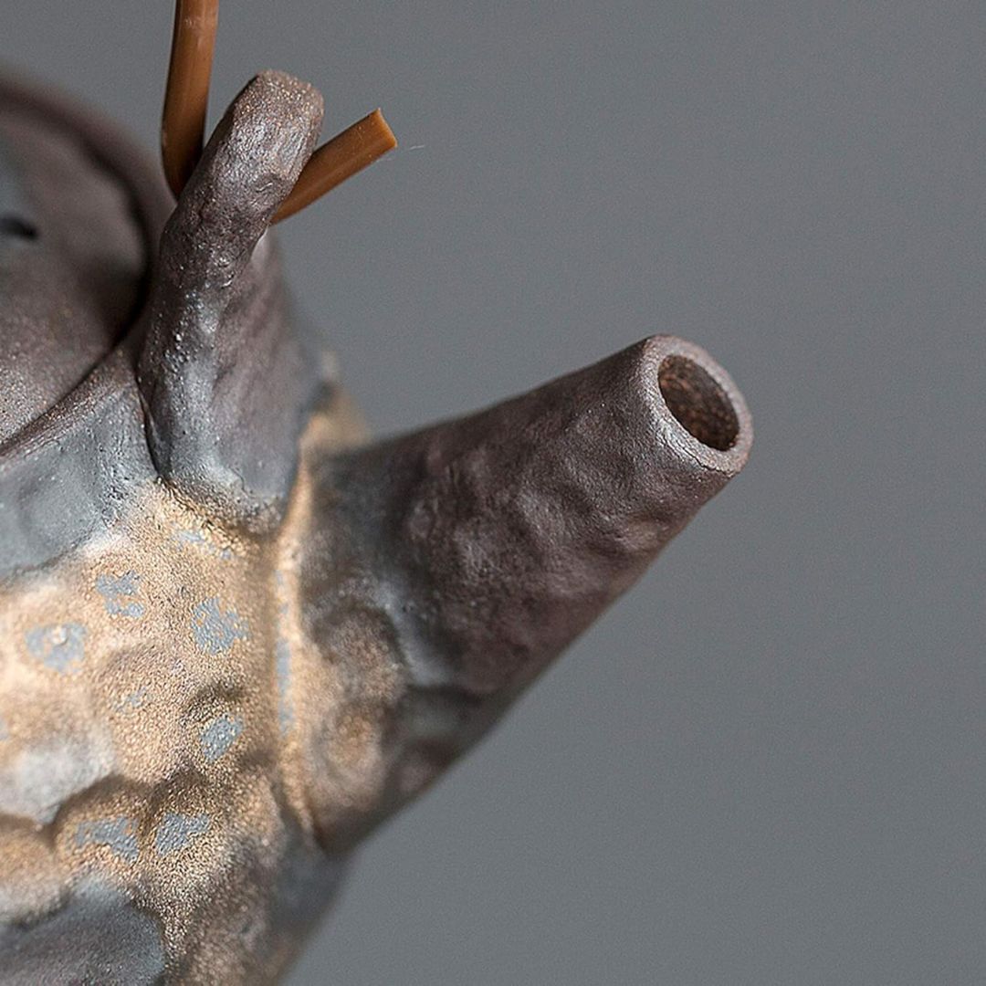 Close-up of a metallic object with a textured surface on a gray background