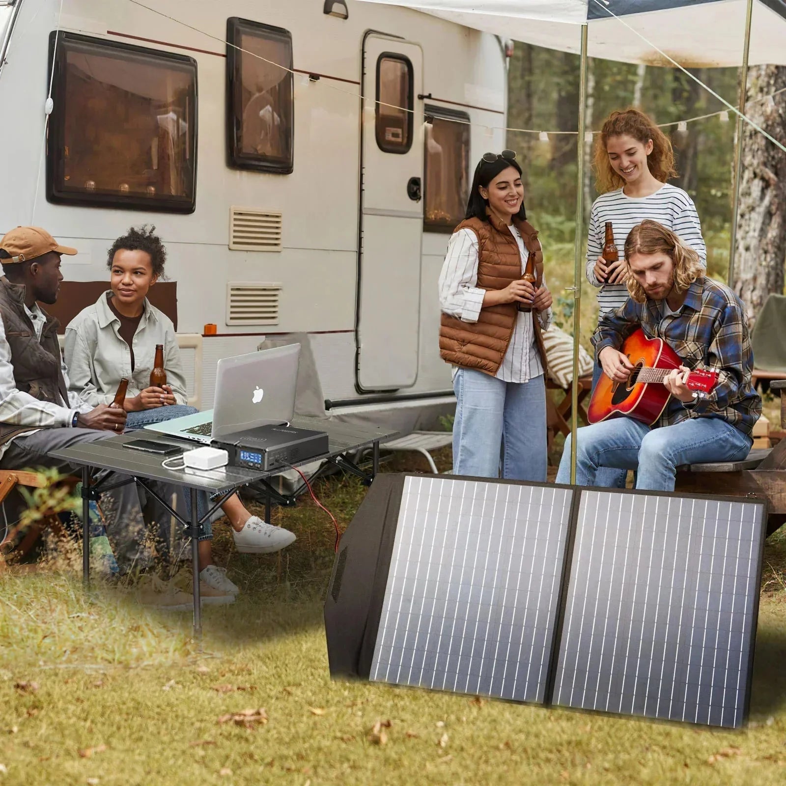 Group of people camping outdoors with a solar panel and laptop.