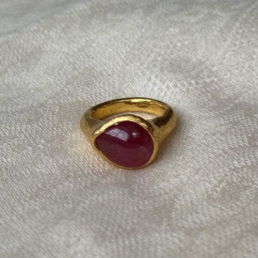 22ct Gold ring with a Ruby stone on a textured white surface