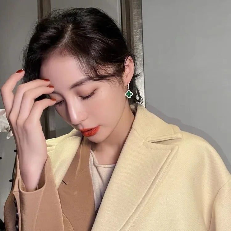Woman wearing a beige coat with a neutral background