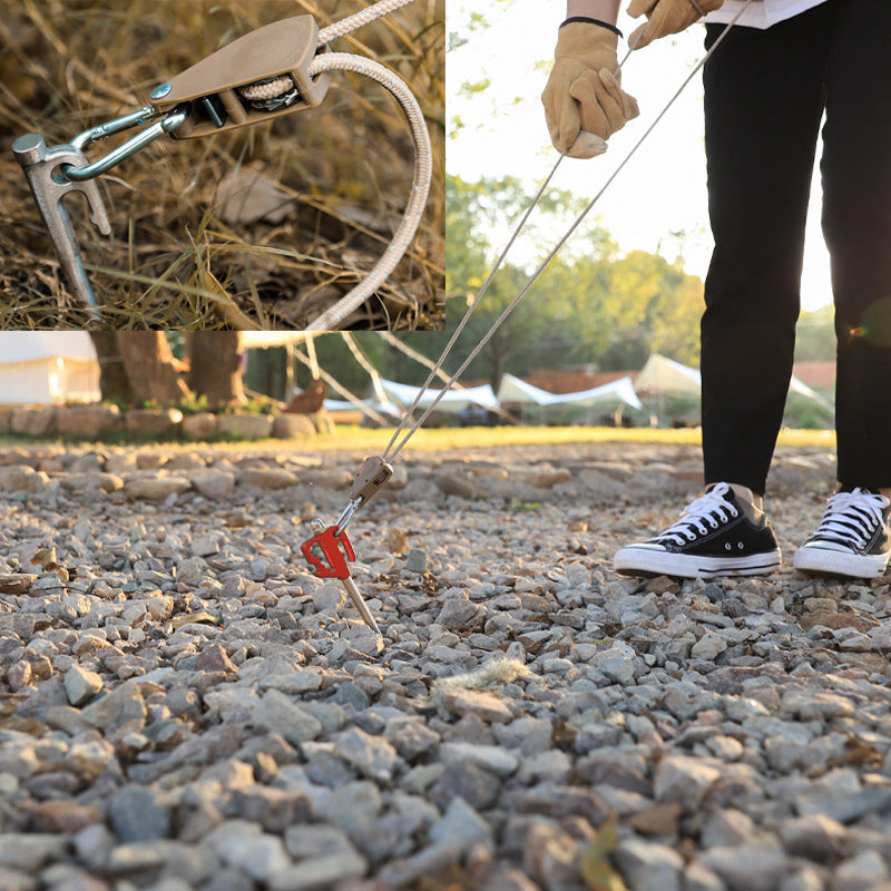Person using a rope to pull something on a gravel surface with close-up details of the equipment.