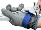 Metallic mesh glove with blue wristband being used to cut a white object.