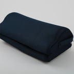 Folded dark blue blanket on a light gray background