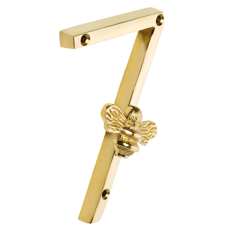 Gold door handle with a bee design on a white background