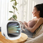 Woman reading a newspaper next to a small air cooler in a bright room.