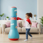 Child in a living room with a blue punching bag, wearing red boxing gloves.