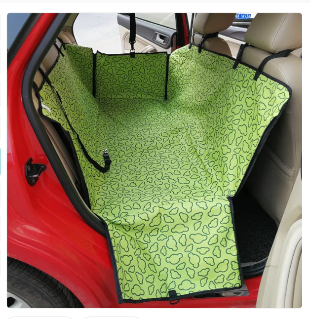 Green pet car seat cover with black pattern on a car seat