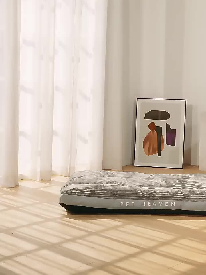 Pet bed with 'Pet Heaven' branding in a room with light-colored curtains and a framed picture on the wall.