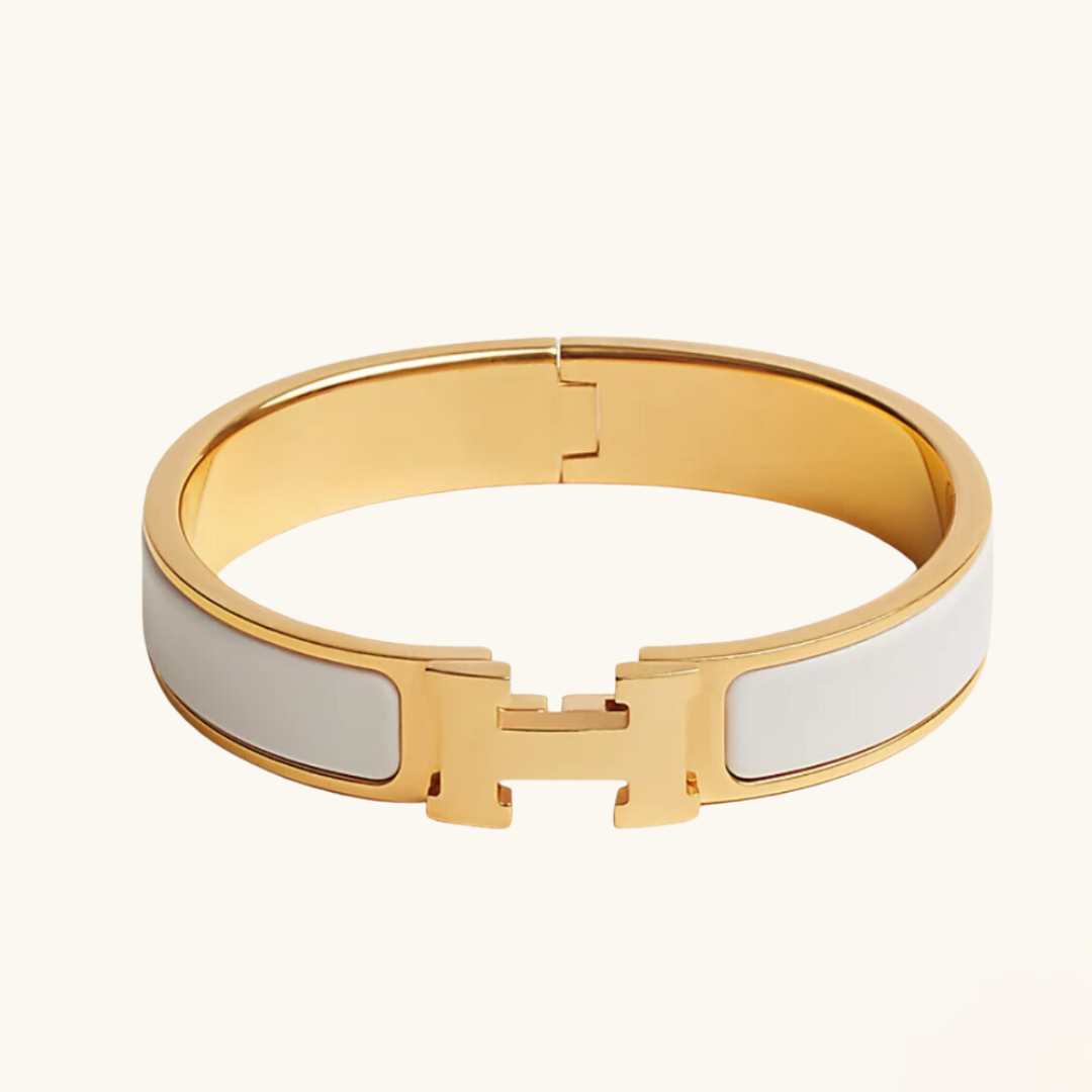 Gold and white bracelet on a white background