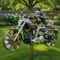 Skeleton figure on a motorcycle in a garden setting