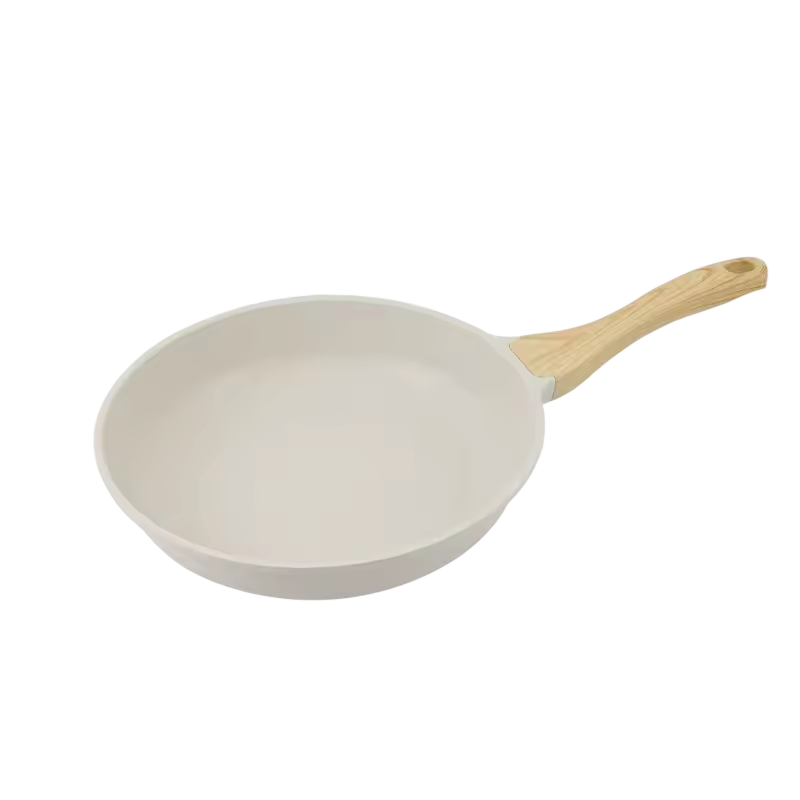 White frying pan with a wooden handle on a white background