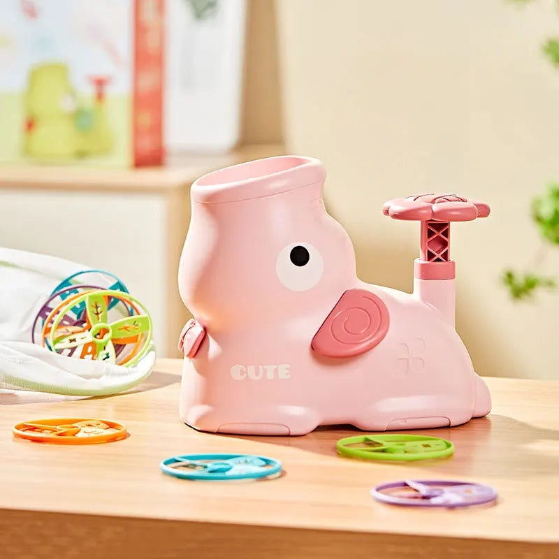 Pink toy duck with a spinning top on a wooden surface