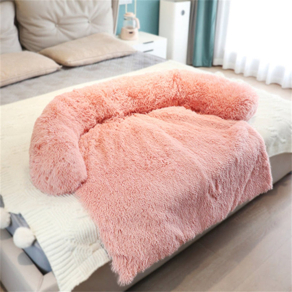 Pink fluffy blanket on a bed in a bedroom setting