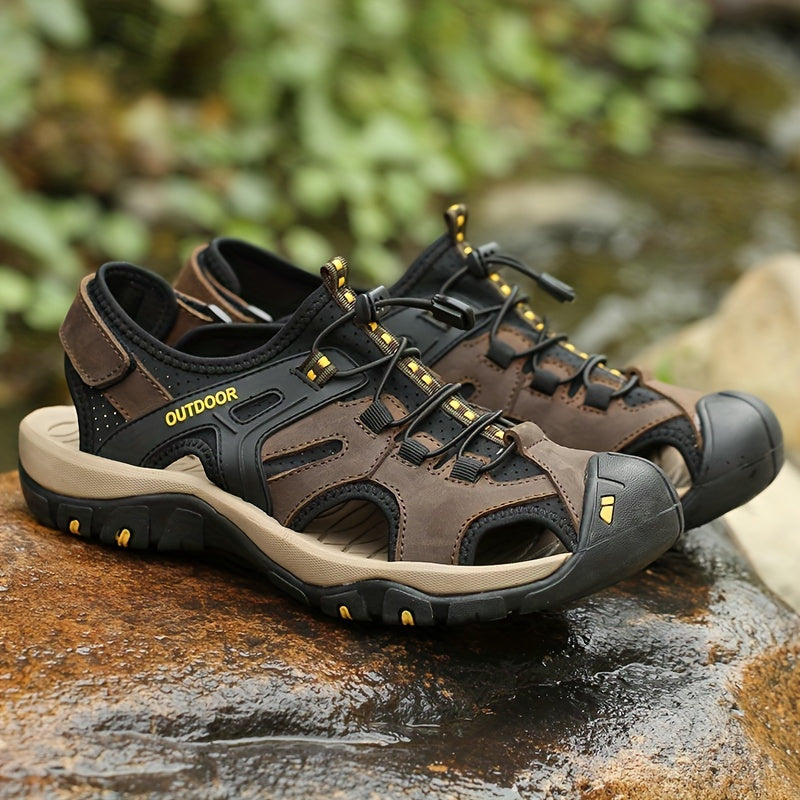 Brown and black outdoor sandals with 'Outdoor' label on a natural background