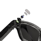 Sunglasses with a clear lens and black frame, showing internal components on a white background.