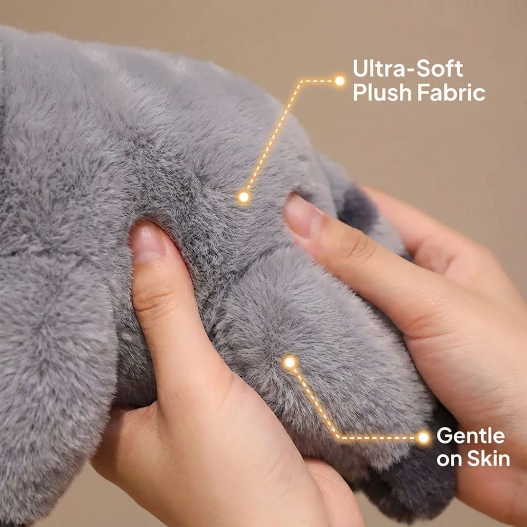 Gray plush toy with hands touching it, highlighting ultra-soft fabric and gentle on skin feature.