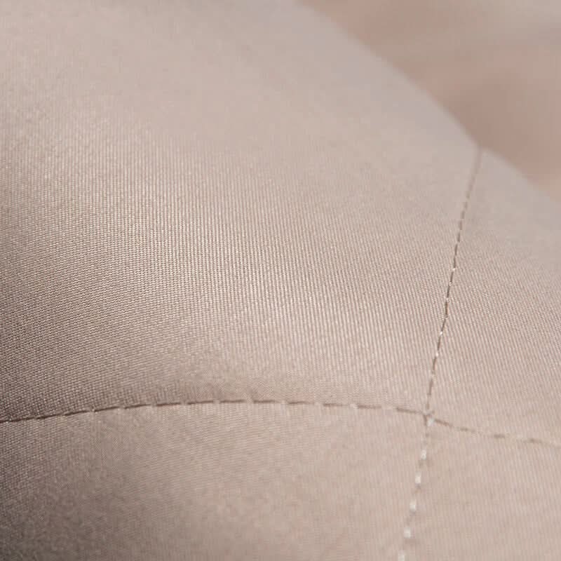 Close-up of beige fabric with a visible seam