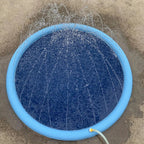 Blue inflatable pool with water splashing on a concrete surface