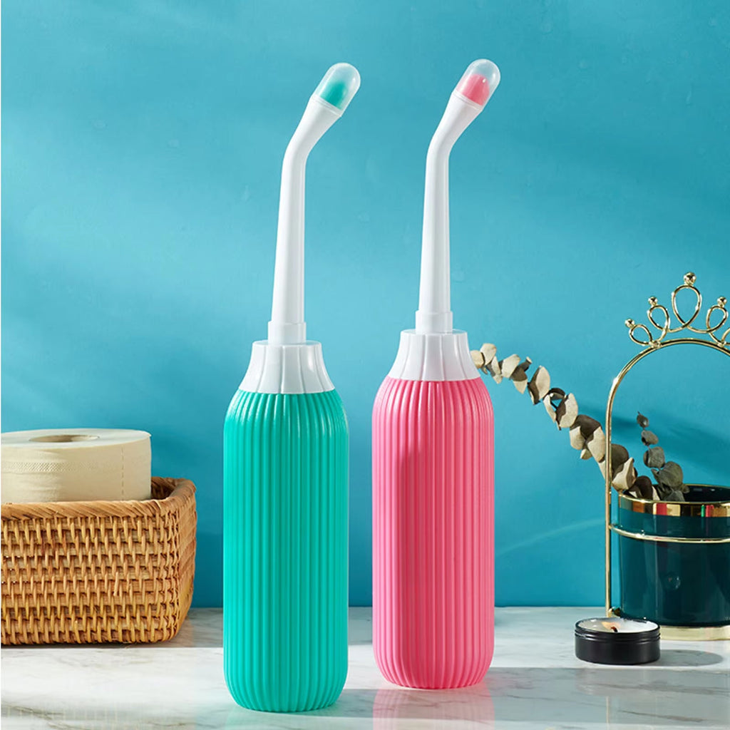 Two dental water flossers, one green and one pink, on a blue background.