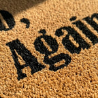 Doormat with 'Welcome' text on a textured surface