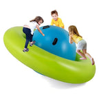 Children playing on a green and blue inflatable boat against a white background