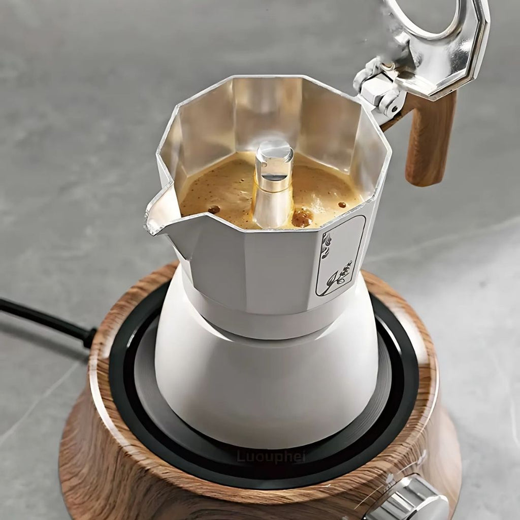 Moka pot with coffee on a wooden burner against a gray background