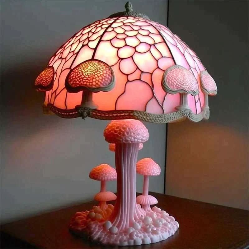 Pink mushroom-themed lamp with stained glass shade on a dark surface