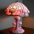 Pink mushroom-themed lamp with stained glass shade on a dark surface