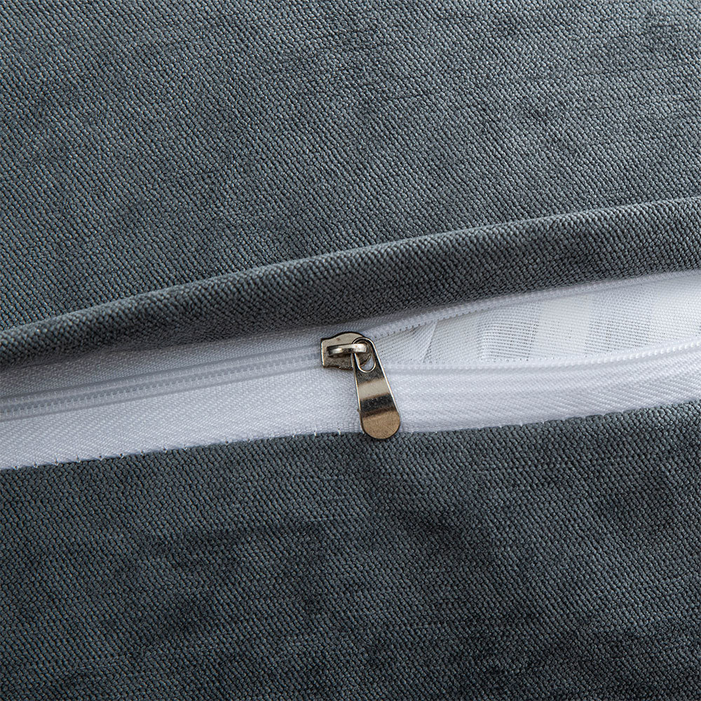 Close-up of a zipper on a gray textured fabric