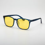 Sunglasses with blue frames and yellow lenses on a light gray background