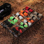 Set of colorful paracord ends on a metal rack with a background of dry grass.