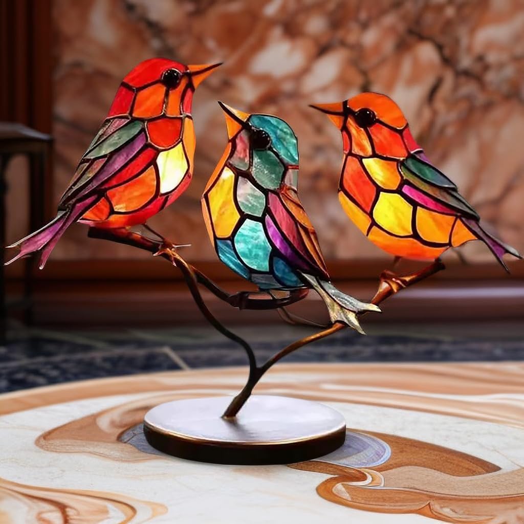 Colorful stained glass bird lamp on a wooden surface with a blurred background