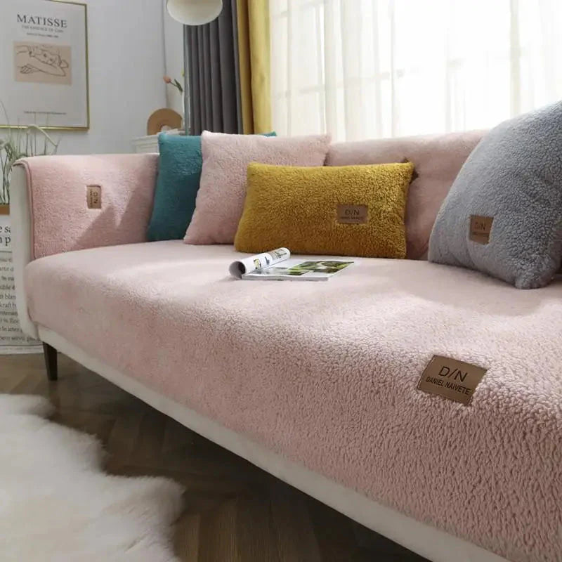 Pink sofa with colorful cushions in a living room setting