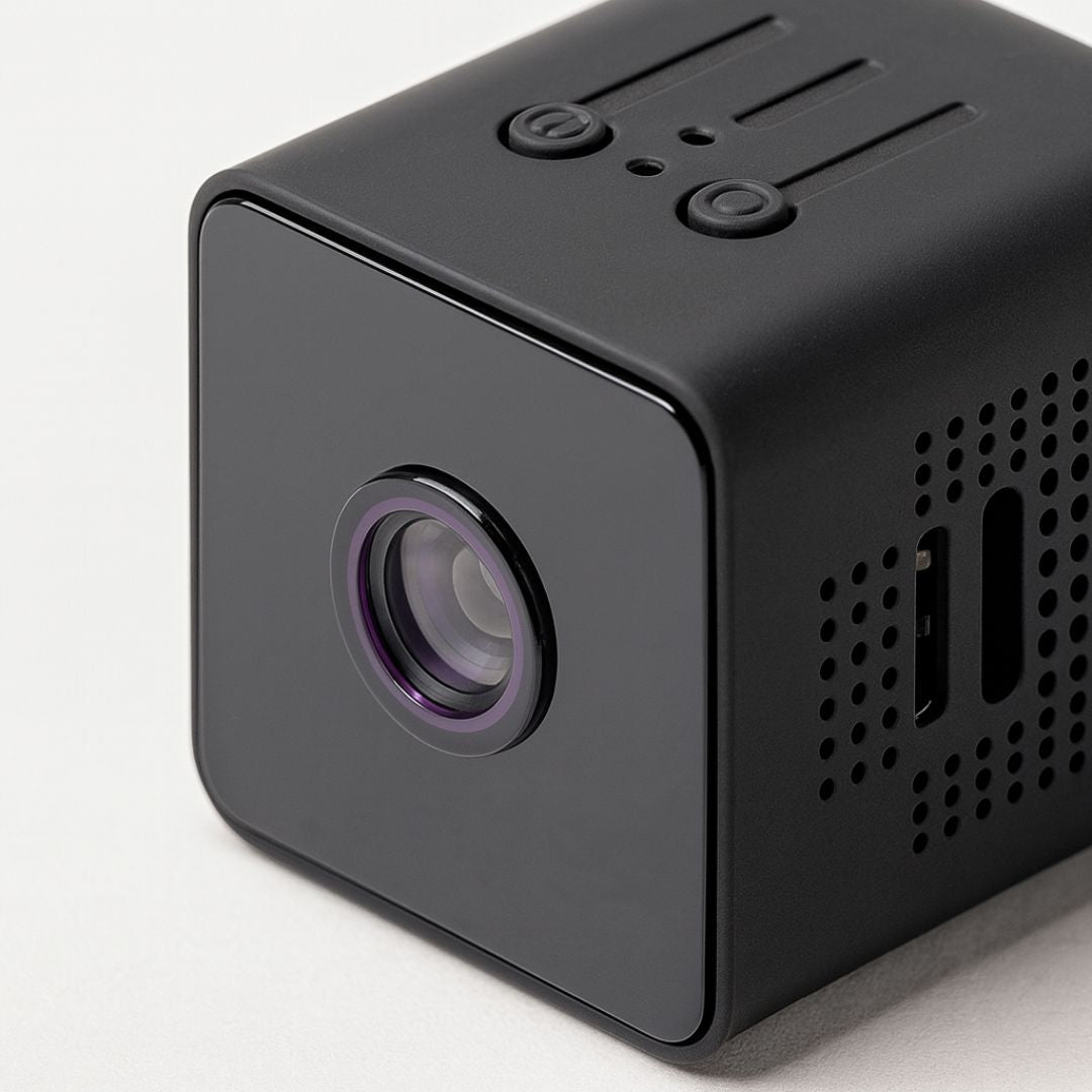 Black portable projector on a light gray background