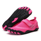 Pink and black water shoes on a white background