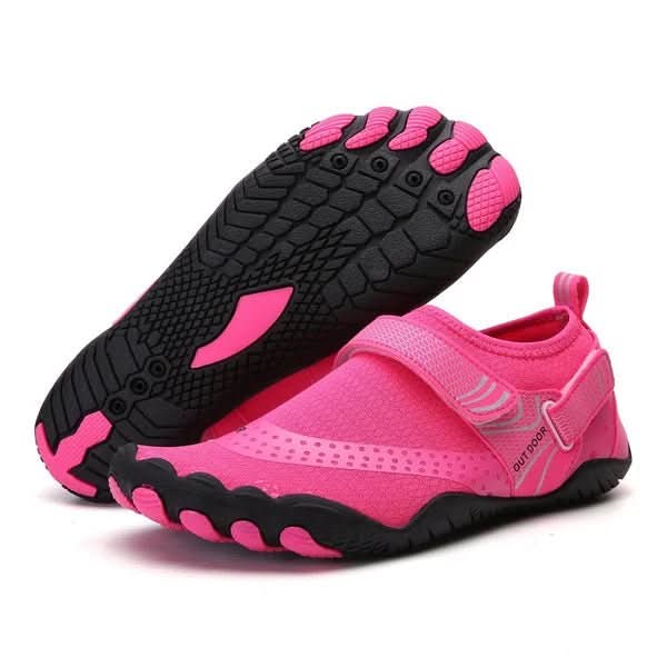 Pink and black water shoes on a white background