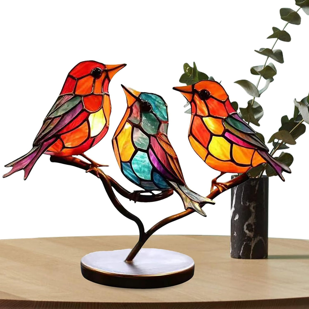 Colorful stained glass birds on a branch with a white background