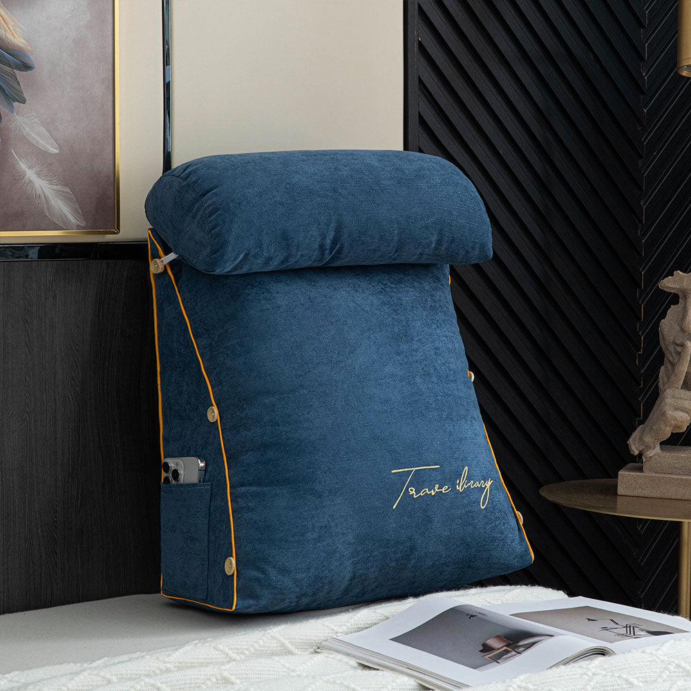 Blue wedge pillow with 'Travel Bug' branding on a bed in a bedroom setting.