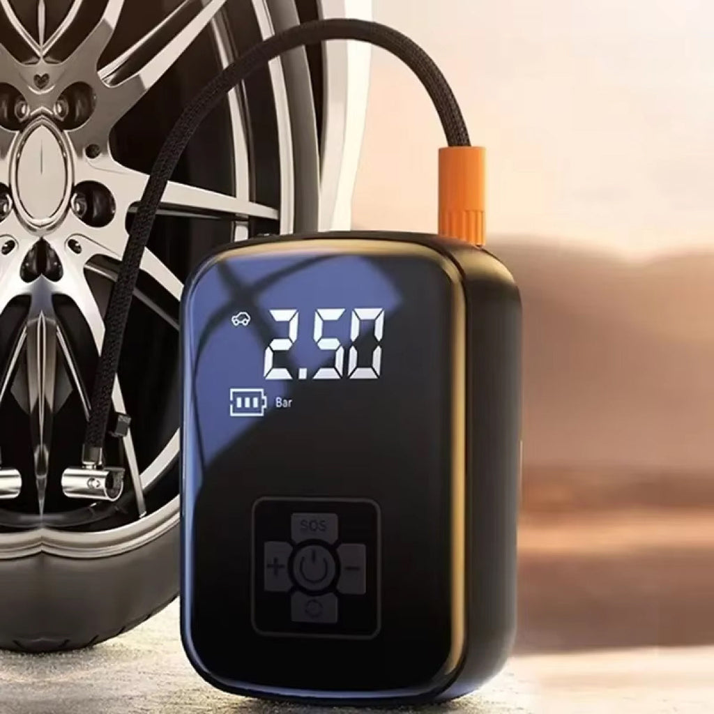 Portable air compressor with digital display next to a car tire