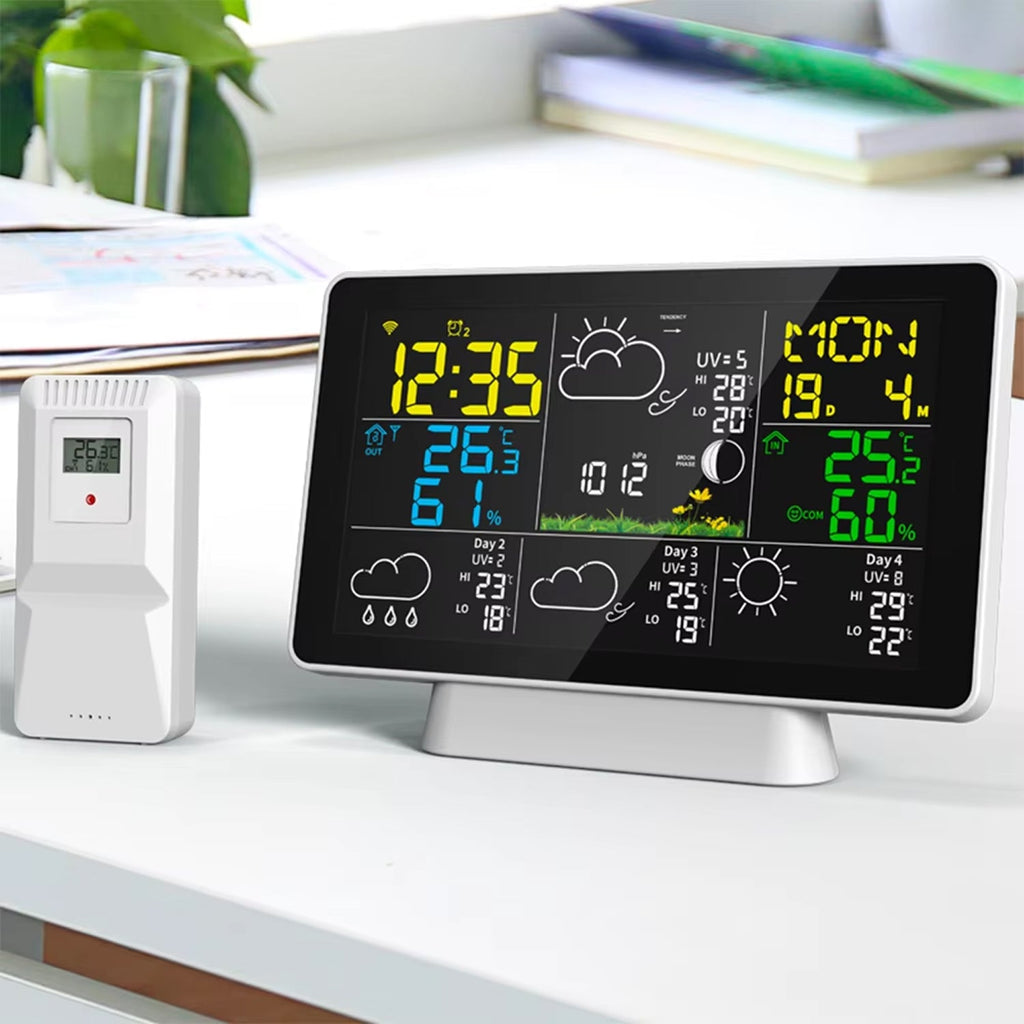 Digital clock with weather display on a desk
