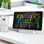 Digital clock with weather display on a desk