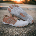 Pair of white and brown shoes on a concrete surface with a sunset in the background