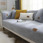 Gray sofa with decorative pillows in a living room setting