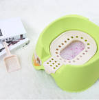 Green pet litter box with a scoop on a white surface