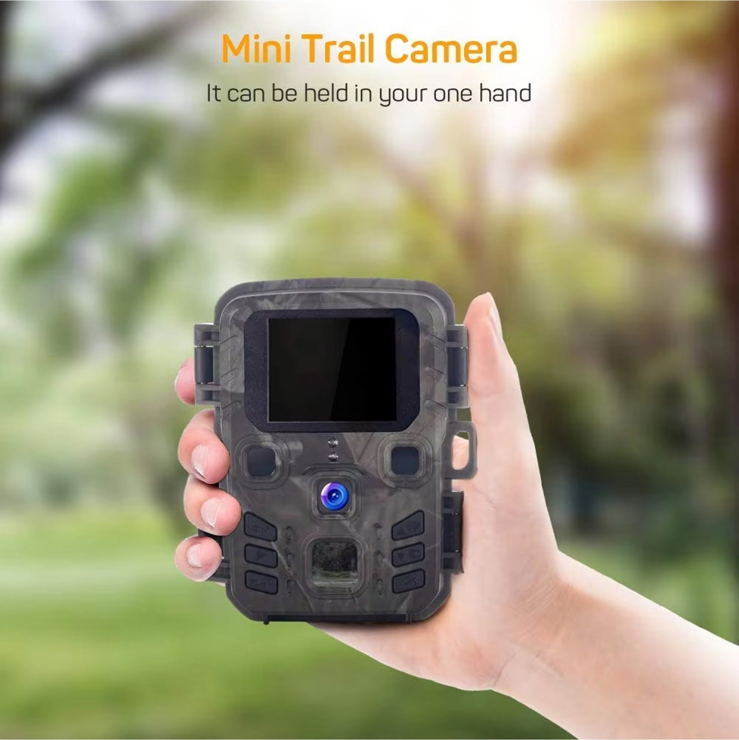 Hand holding a mini trail camera with a blurred natural background