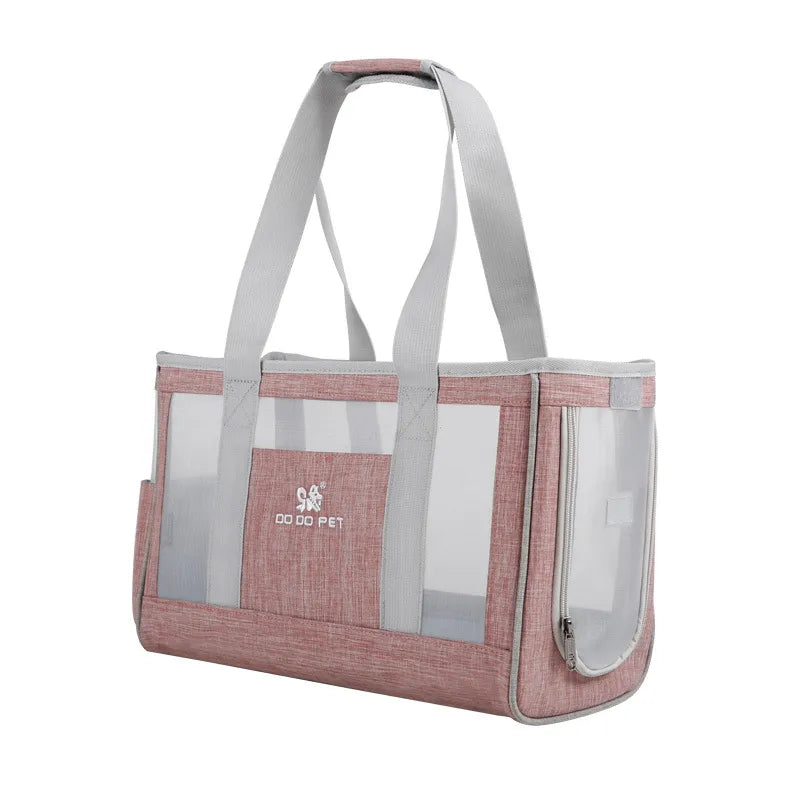 Pink pet carrier with mesh sides on a white background