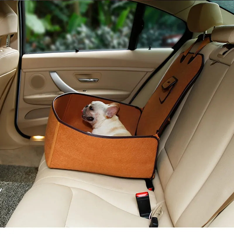 Dog in an orange car seat cover inside a vehicle