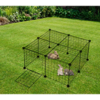 Pet playpen with small animals inside on a grassy area